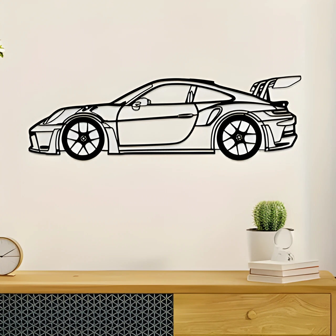 Black iron sports car wall art decoration on a white wall
