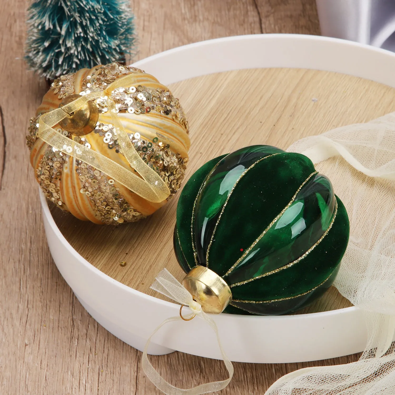 Green and yellow striped flocking Christmas glass ball decoration with mosaic surface on white background