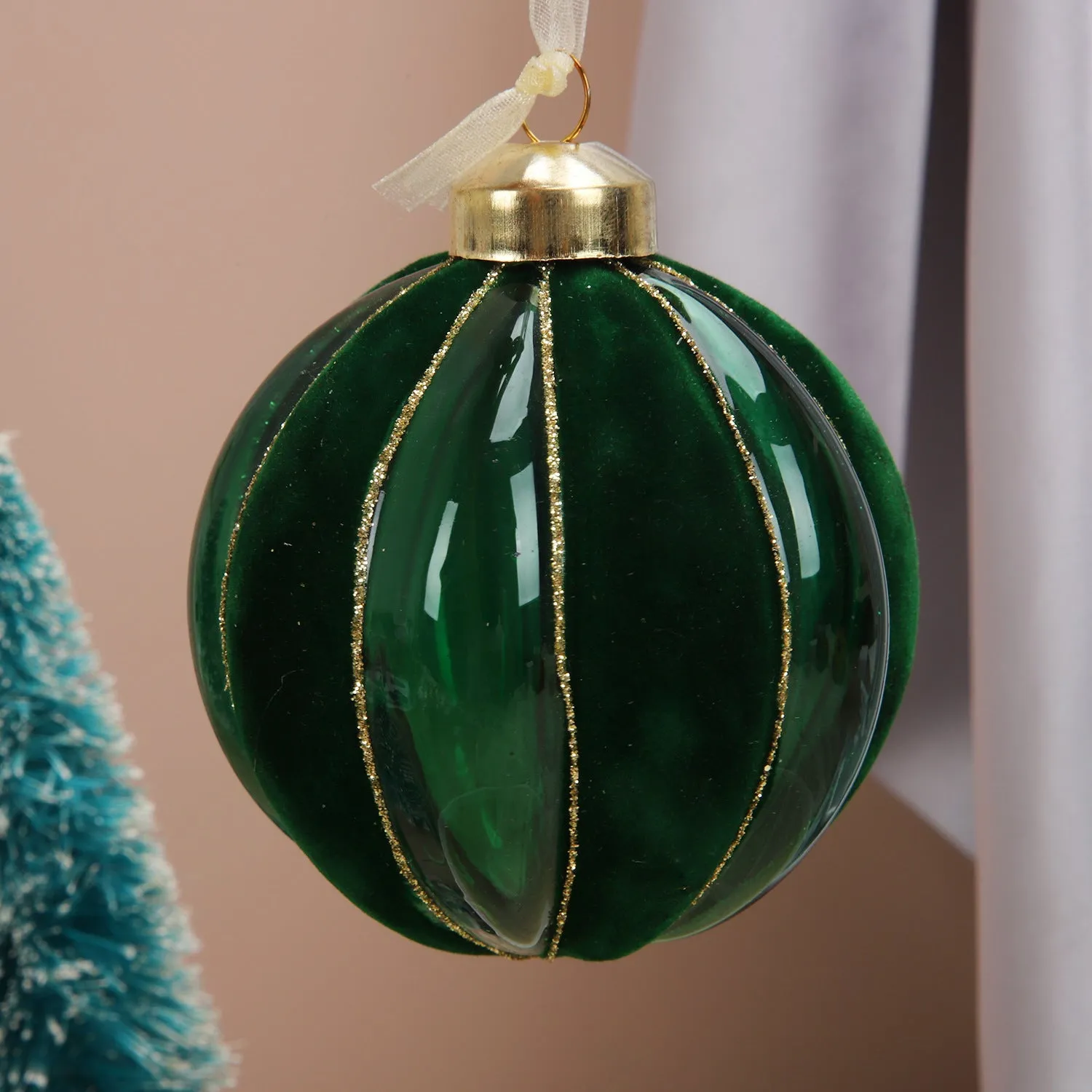 Green and yellow striped flocking Christmas glass ball decoration with mosaic surface on white background