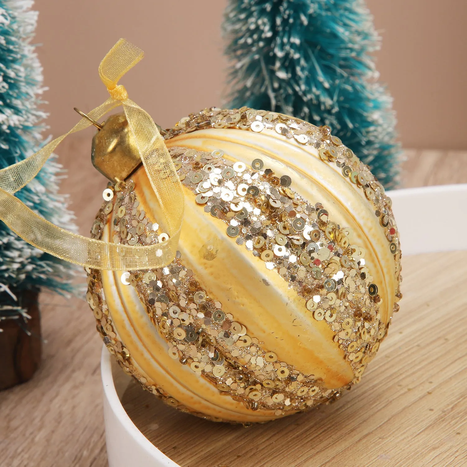 Green and yellow striped flocking Christmas glass ball decoration with mosaic surface on white background