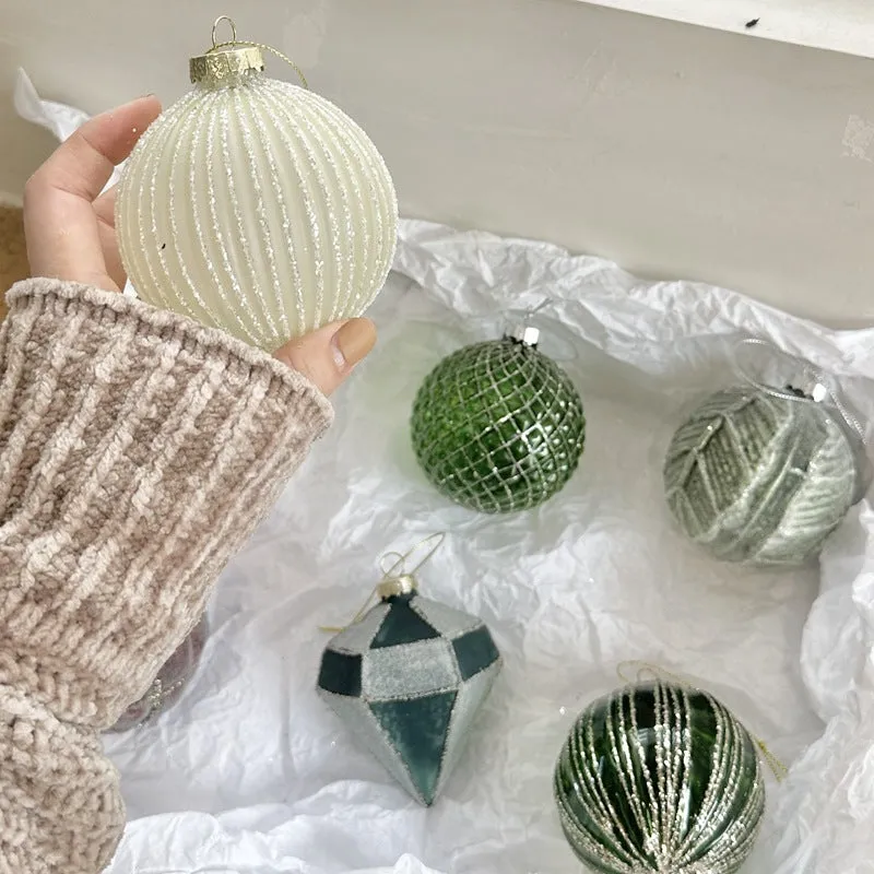 Handmade glass Christmas bauble 8cm diameter in green on branch