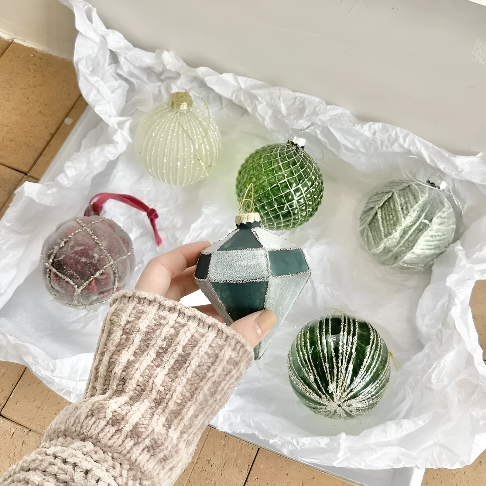 Handmade glass Christmas bauble 8cm diameter in green on branch