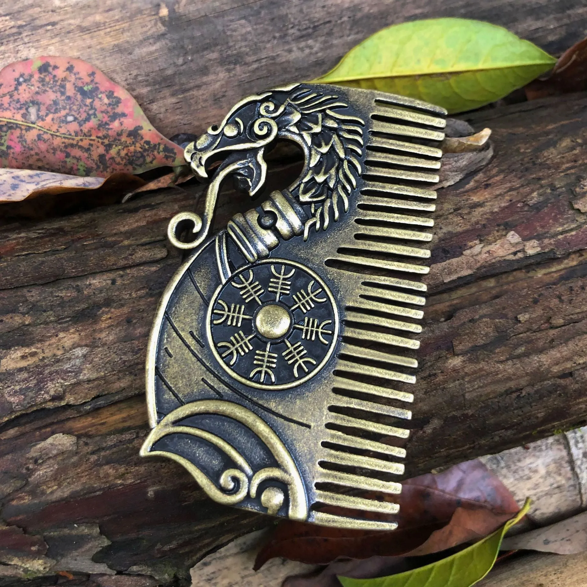 Bronze double-sided Viking rune comb with dragon motif on neutral background