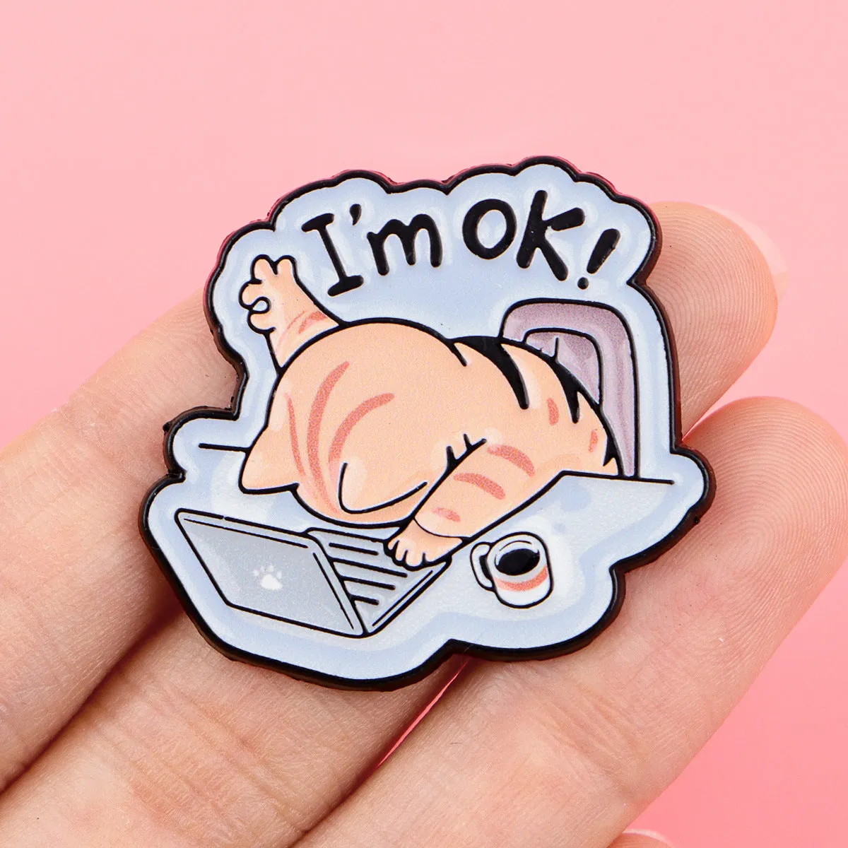 Cat shaped alloy brooch with dripping oil finish on a neutral background showing the pin clasp.