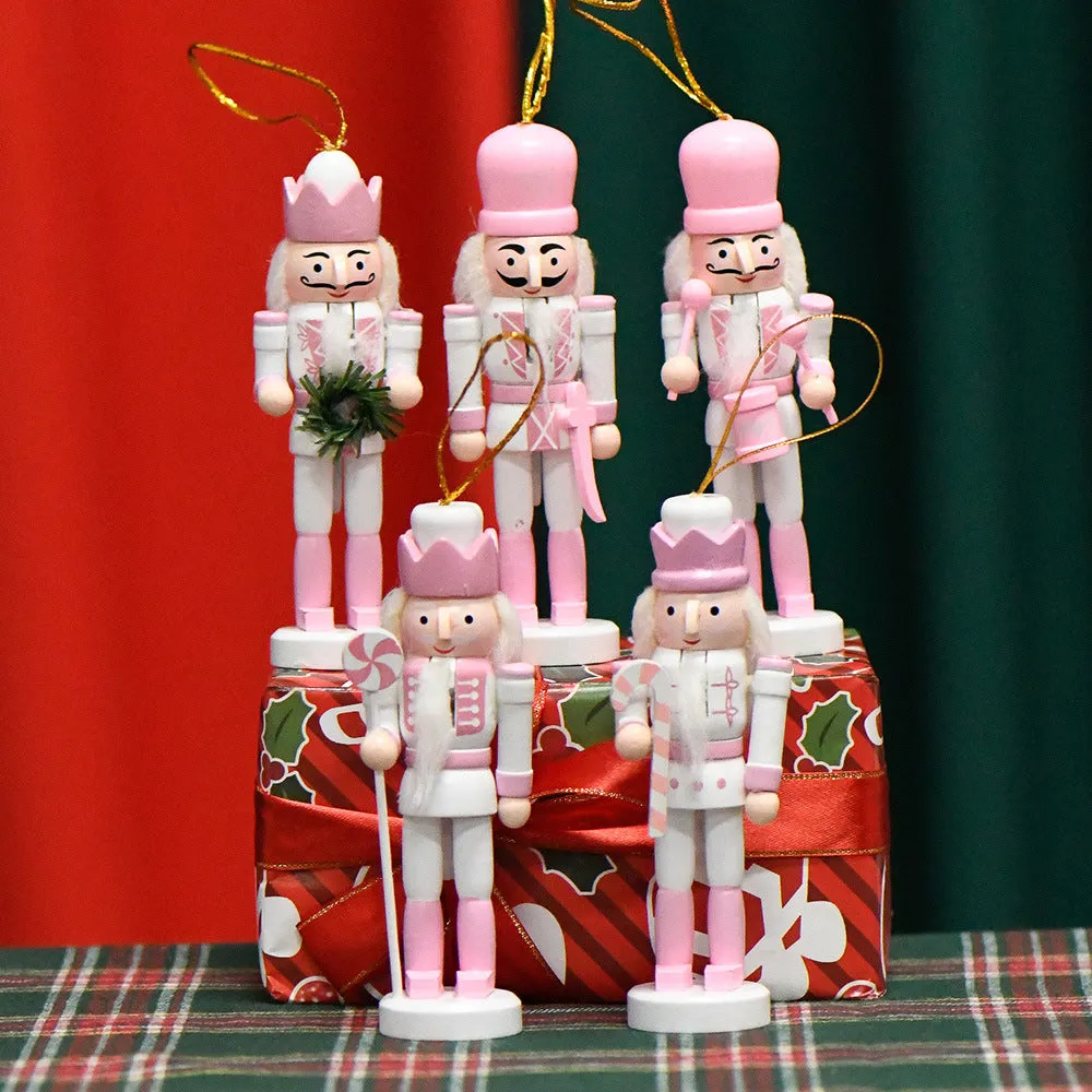 Five pink wooden nutcracker soldier puppets each 13cm tall arranged as Christmas garland ornaments