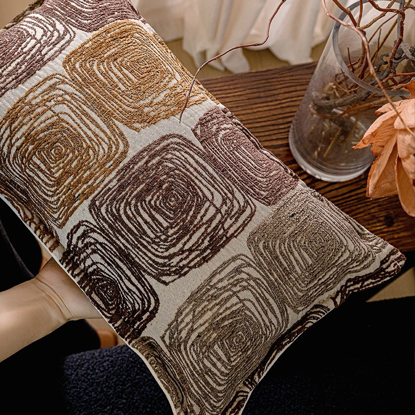 Cream and coffee coloured abstract coil pattern pillow cover shown in square and waist pillow sizes.