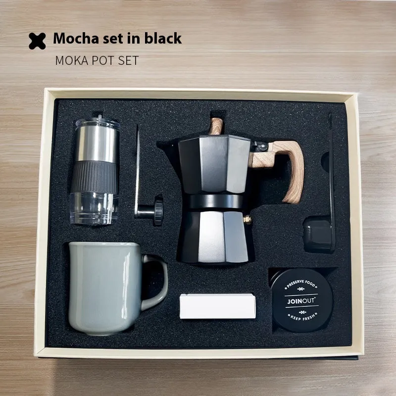 Six-piece manual grinding machine set in beige and black with moka pot, cup, bean jar, and accessories