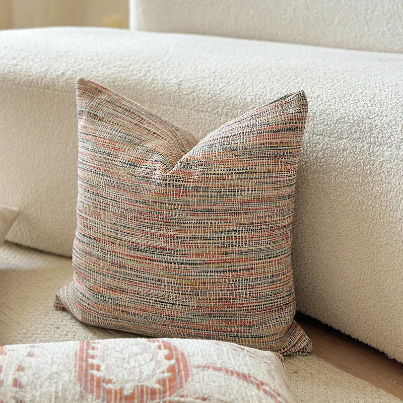Amber American-style jacquard pillow cover with paisley and flower pattern on a sofa.