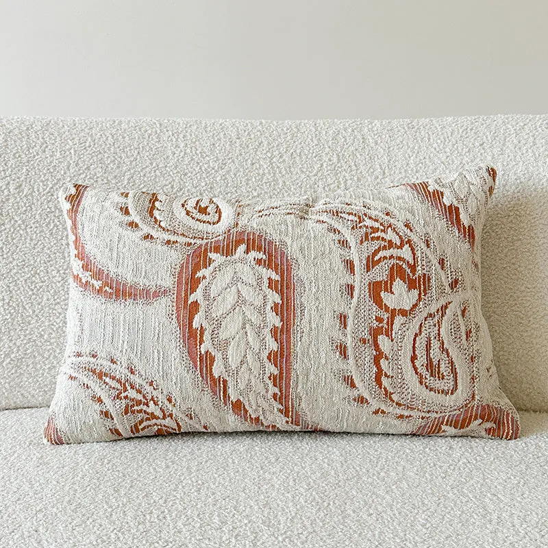 Amber American-style jacquard pillow cover with paisley and flower pattern on a sofa.