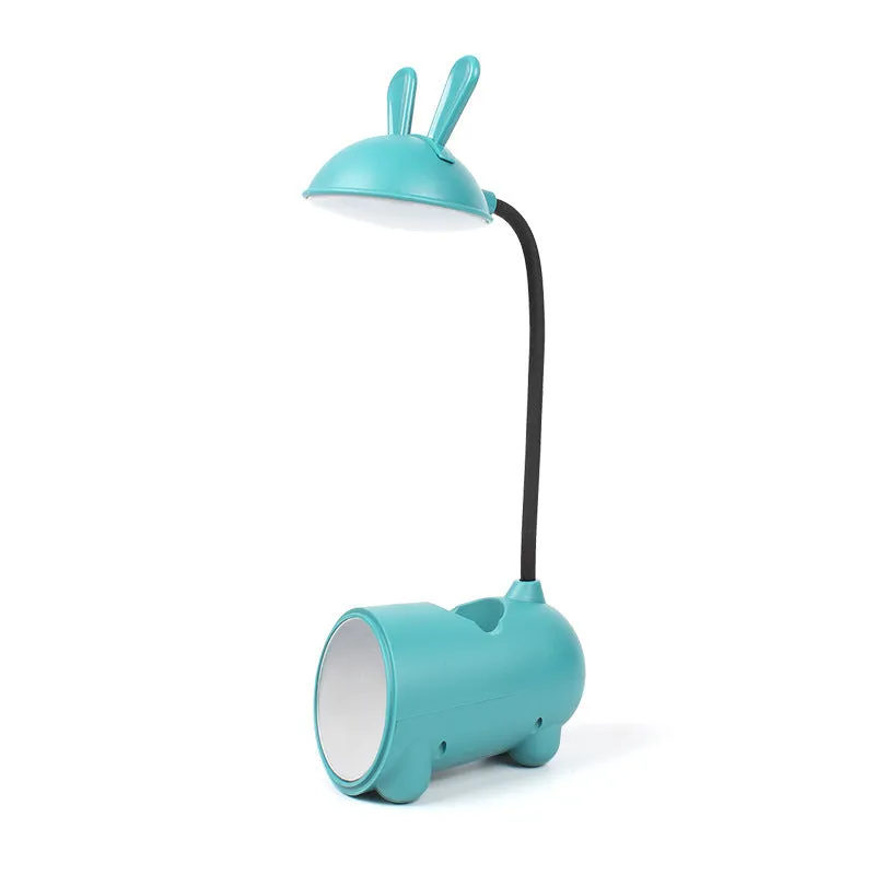 Cartoon-style USB table lamp with integrated pen container in green colour on wooden desk