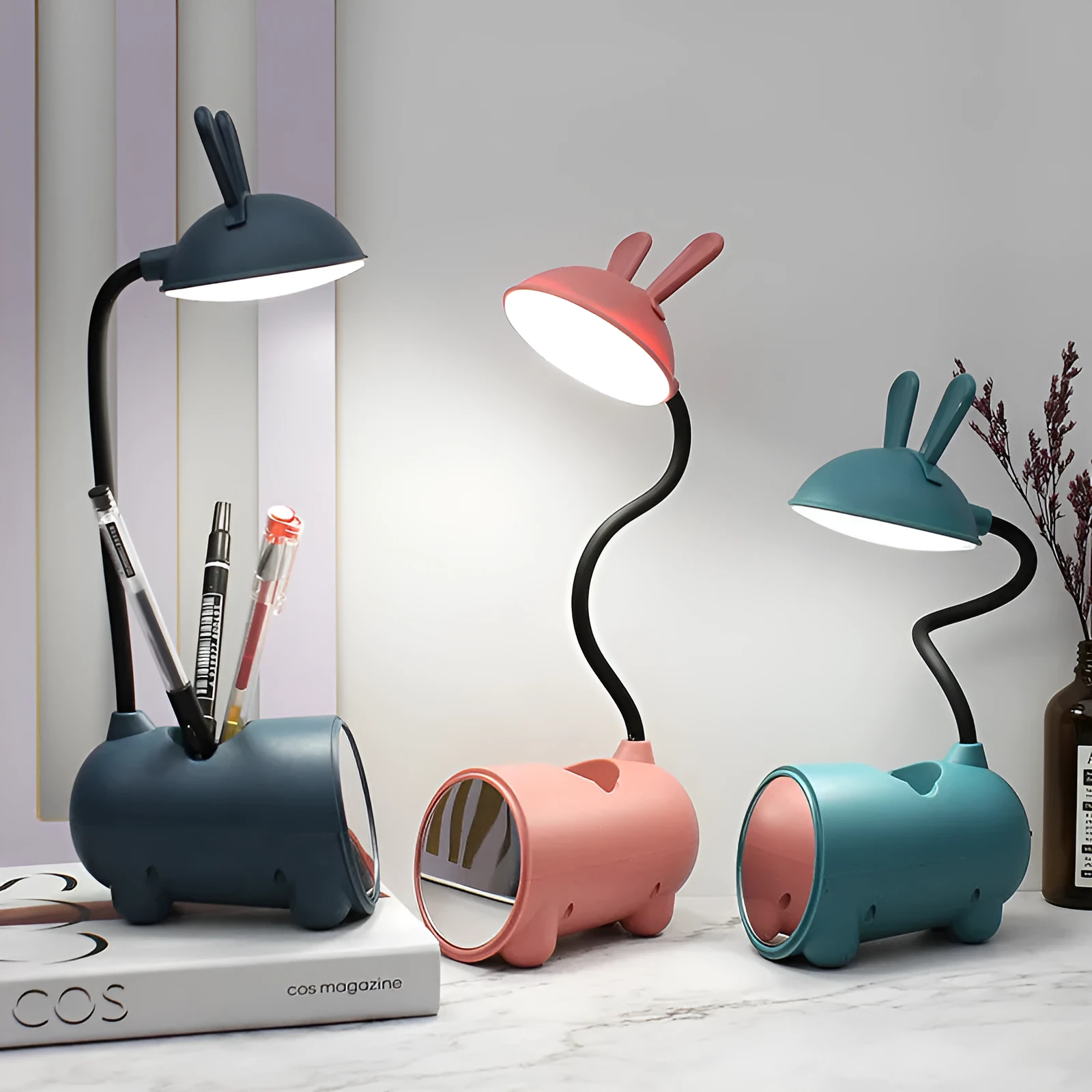 Cartoon-style USB table lamp with integrated pen container in green colour on wooden desk