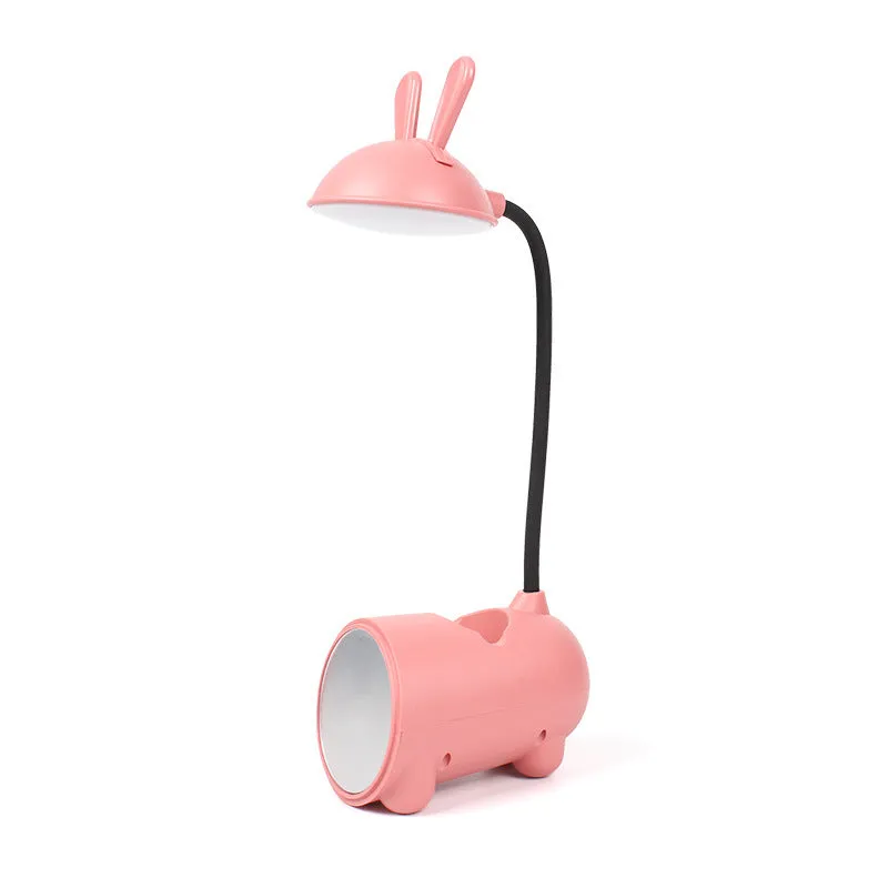Cartoon-style USB table lamp with integrated pen container in green colour on wooden desk