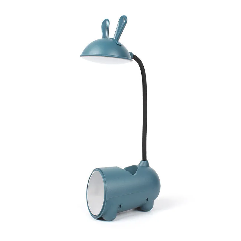 Cartoon-style USB table lamp with integrated pen container in green colour on wooden desk