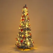 Green velvet foldable telescopic Christmas tree with warm lights on floor-standing base in indoor room setting