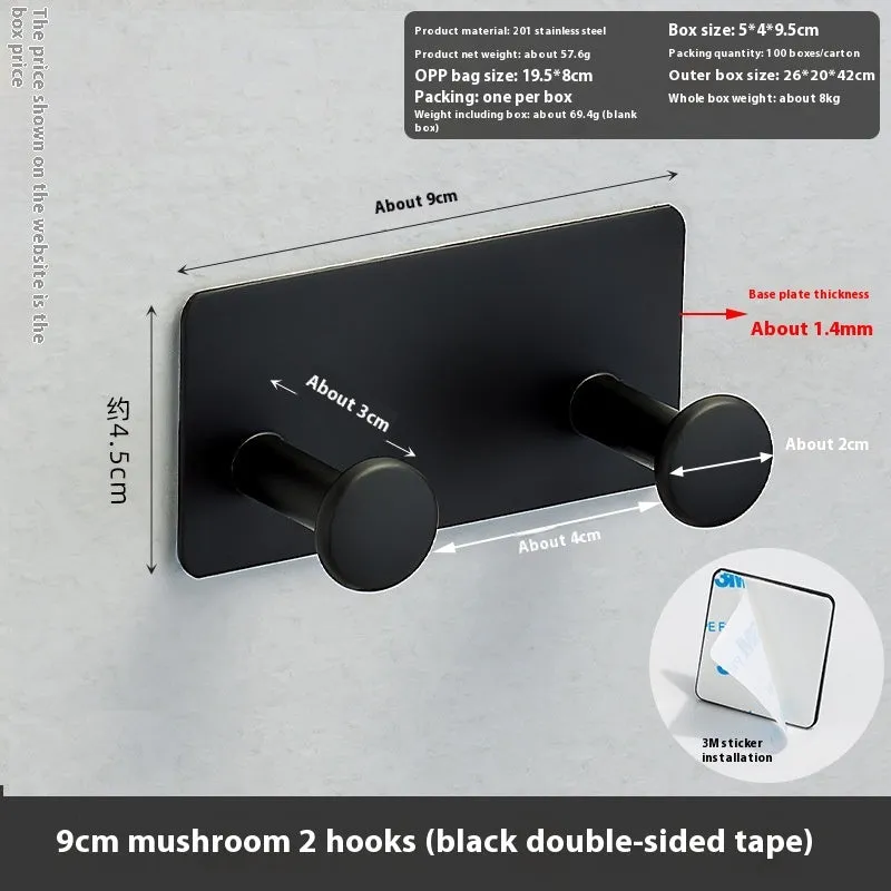 Black screwless adhesive wall hook with three hooks mounted on a glass shower door