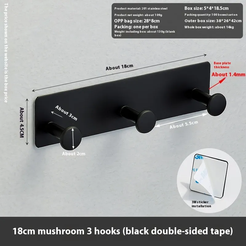 Black screwless adhesive wall hook with three hooks mounted on a glass shower door