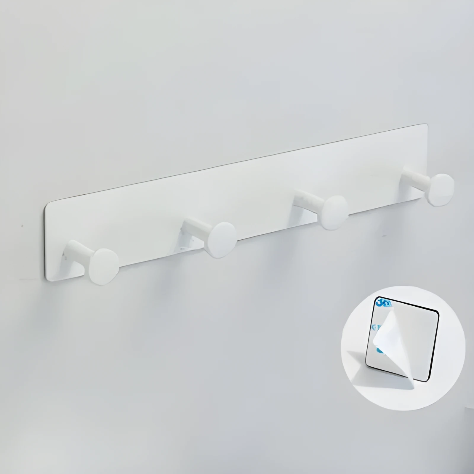 Black screwless adhesive wall hook with three hooks mounted on a glass shower door