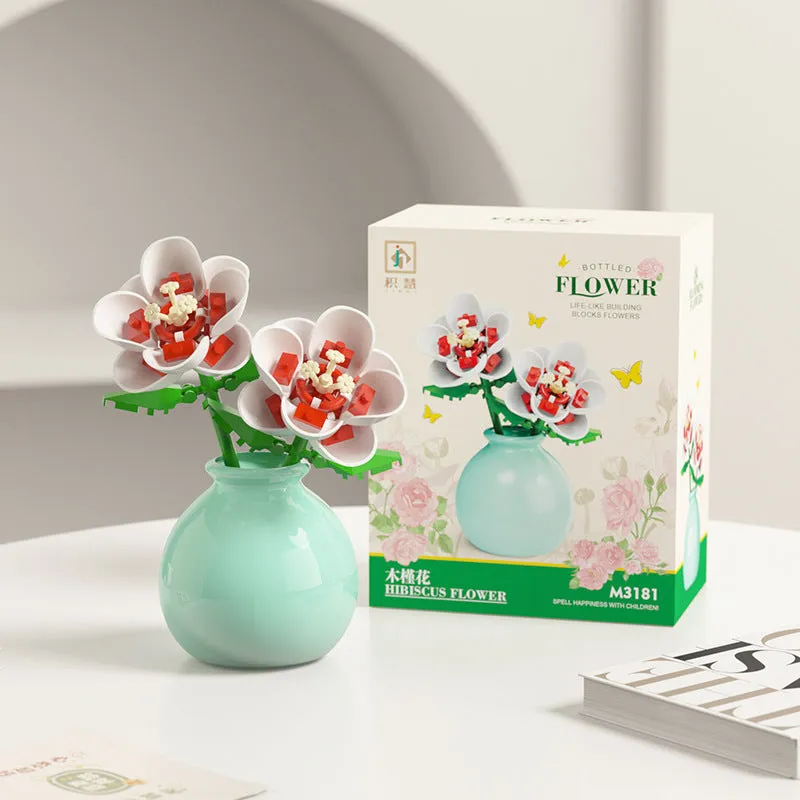 Assembled plastic building block flower in vase on tabletop