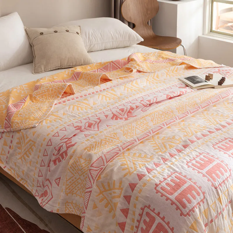 Pure cotton washed cover blanket with geometric pattern in glini pink, folded on a bed
