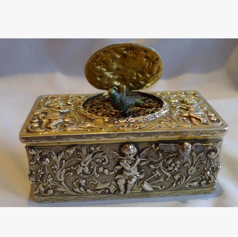 Gold alloy automatic pop-up bird box decoration on a tabletop, 10x6x4 cm