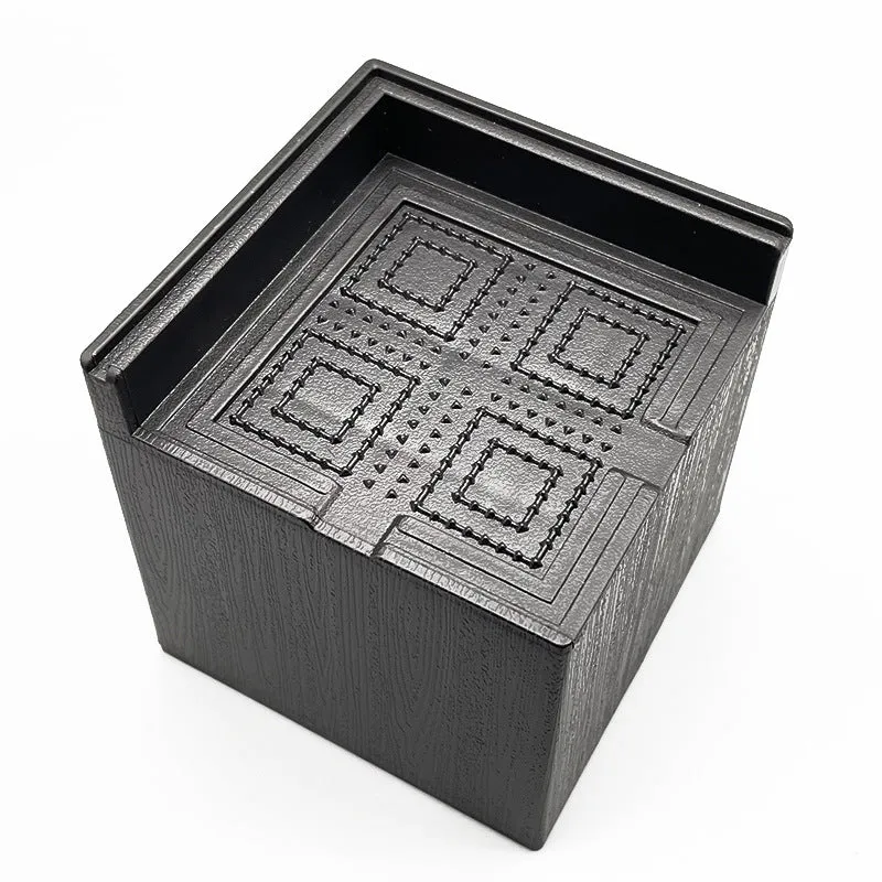 Four black plastic furniture foot mats for height adjustment and floor protection