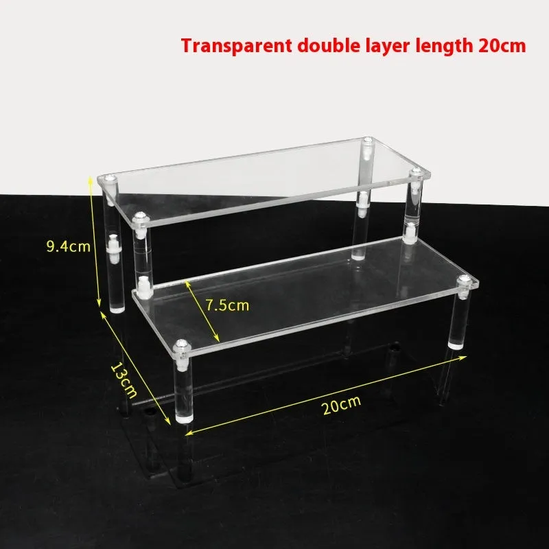 Transparent acrylic ladder display rack with three trapezoidal tiers showing blind box figurines on a desk