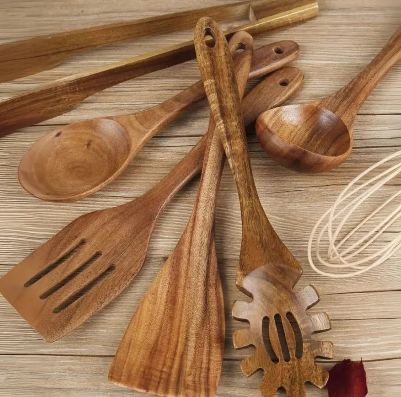Natural wood 7-piece cooking utensil set for non-stick pans on a kitchen counter.