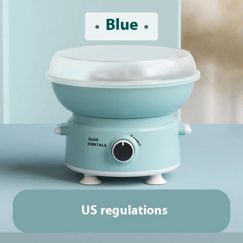 Mini cotton candy machine in blue with metal body and round heating tube on a countertop