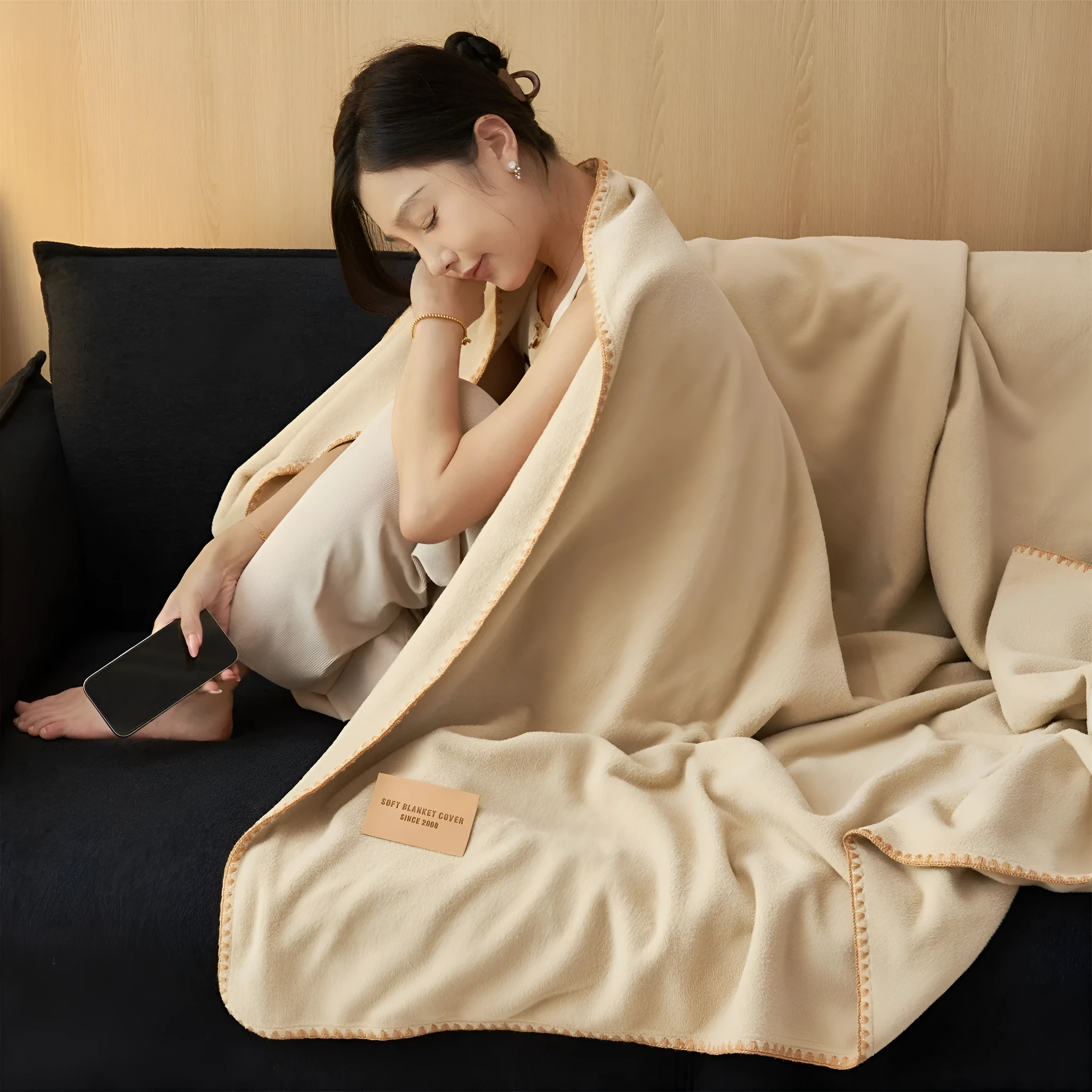Class A Alpaca Fleecefiber blanket in solid colour, folded on a sofa, showing soft polyester texture