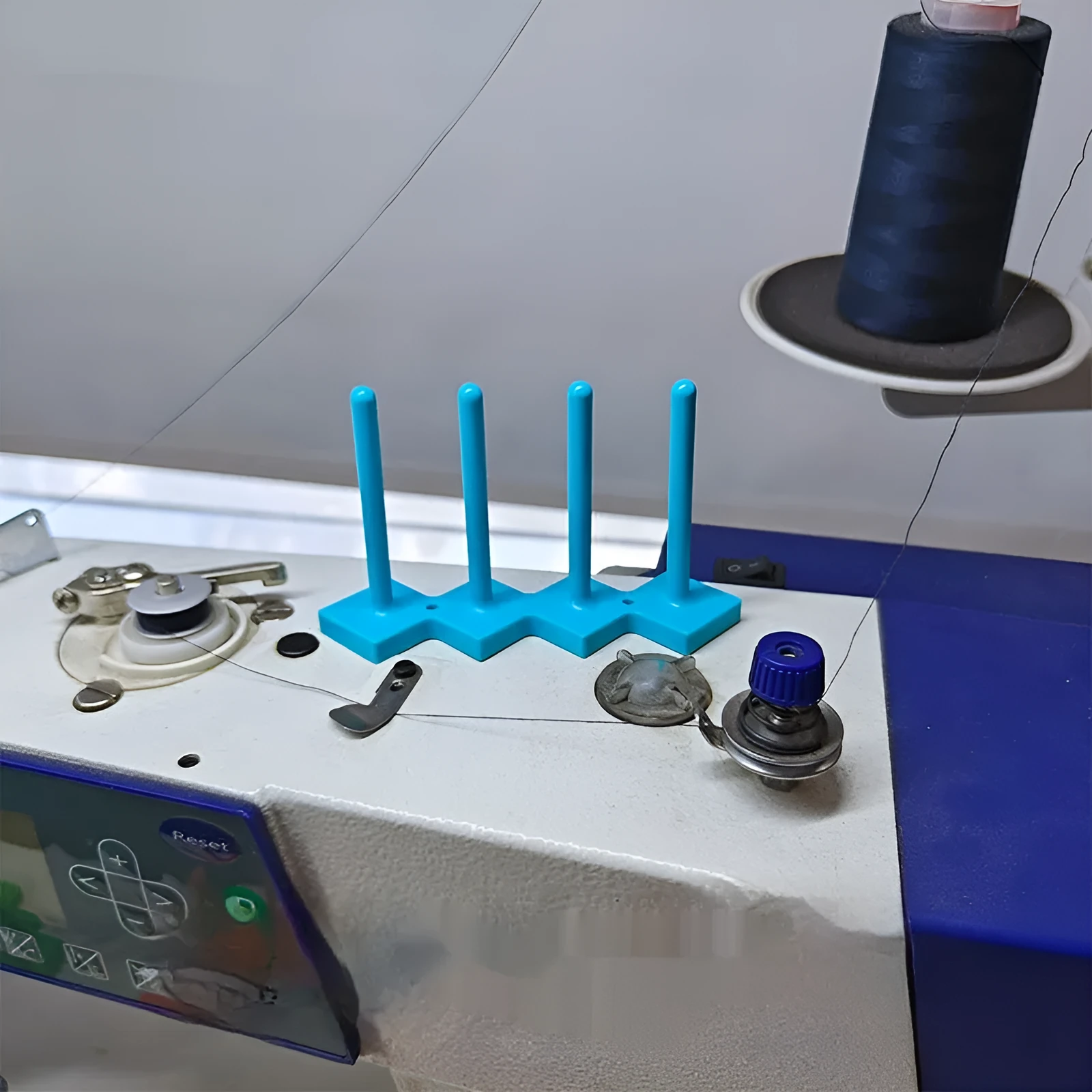 Plastic sewing machine bobbin storage rack with magnetic wire core bracket and four columns in blue, green, orange, red