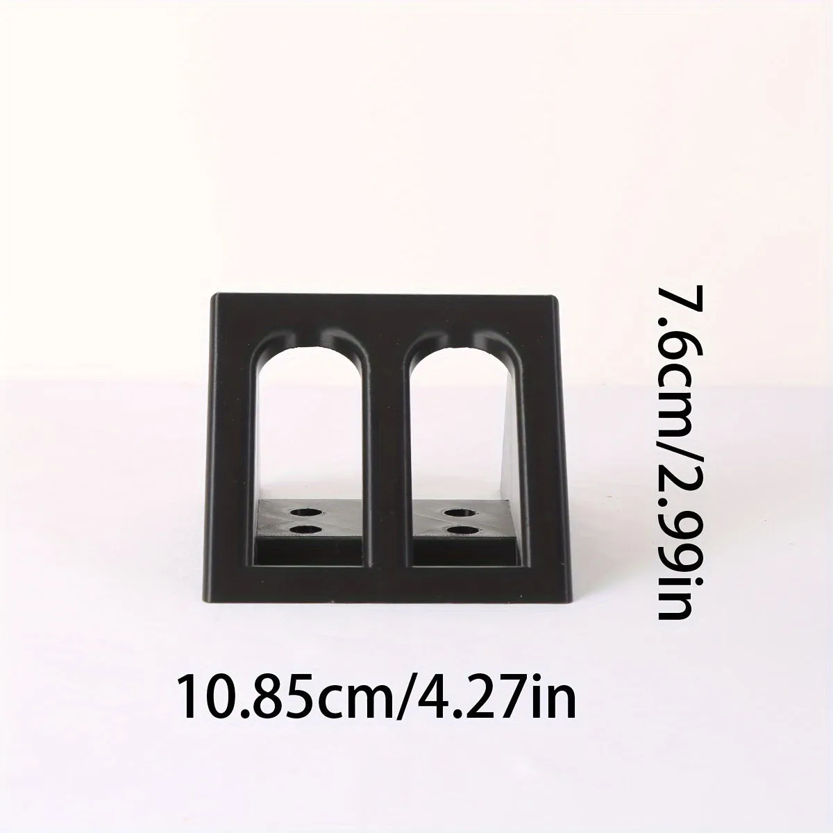Black punk-style plastic pistol stand for displaying an airsoft gun.