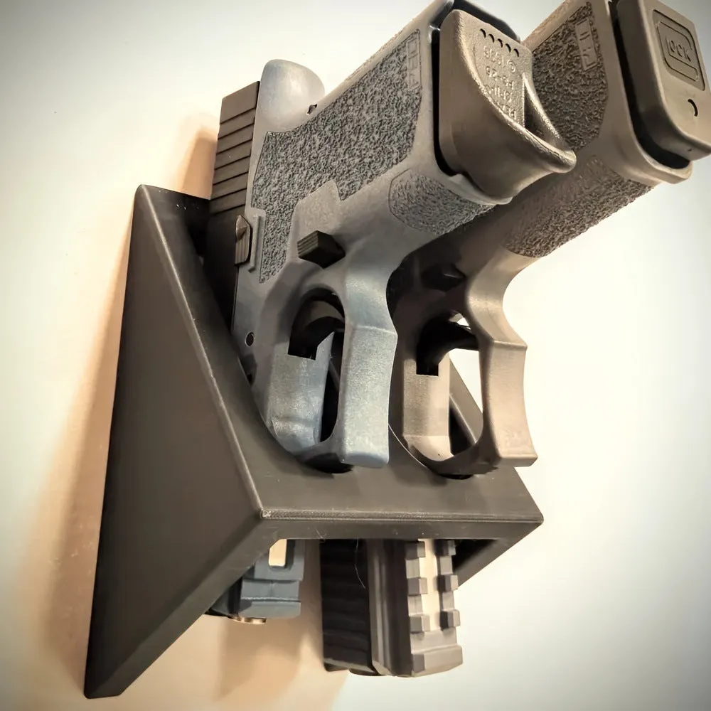 Black punk-style plastic pistol stand for displaying an airsoft gun.