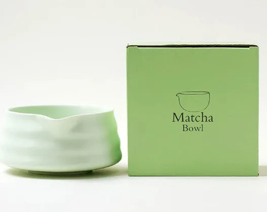 Ceramic matte tea whisk stand in Japanese style on a neutral background with a tea whisk placed upright inside the holder