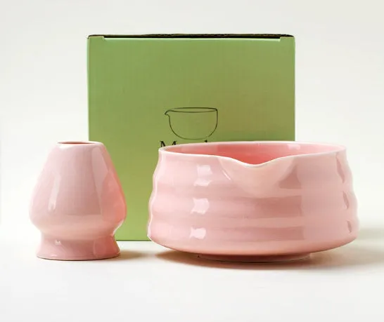 Ceramic matte tea whisk stand in Japanese style on a neutral background with a tea whisk placed upright inside the holder