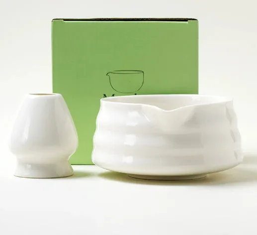 Ceramic matte tea whisk stand in Japanese style on a neutral background with a tea whisk placed upright inside the holder