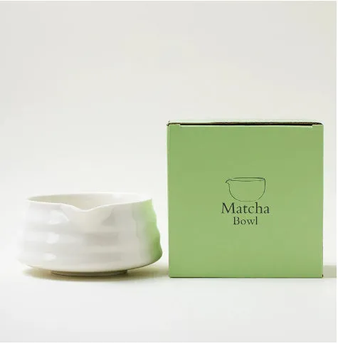 Ceramic matte tea whisk stand in Japanese style on a neutral background with a tea whisk placed upright inside the holder