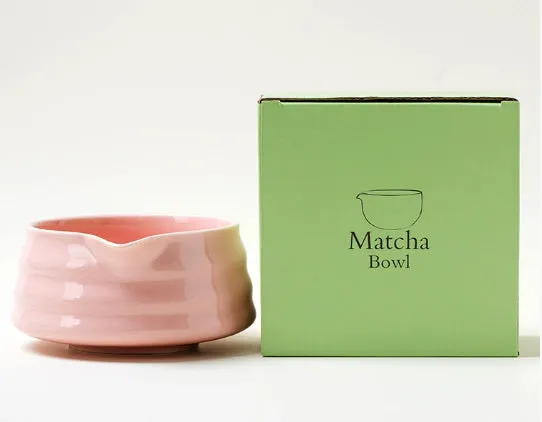 Ceramic matte tea whisk stand in Japanese style on a neutral background with a tea whisk placed upright inside the holder