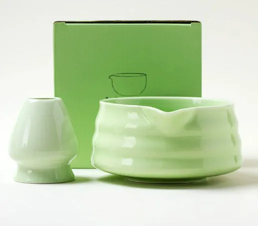 Ceramic matte tea whisk stand in Japanese style on a neutral background with a tea whisk placed upright inside the holder
