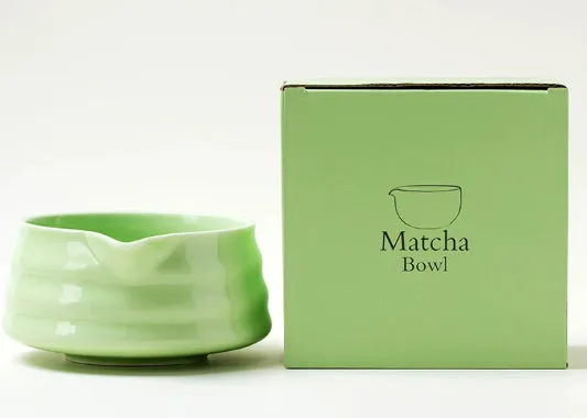 Ceramic matte tea whisk stand in Japanese style on a neutral background with a tea whisk placed upright inside the holder