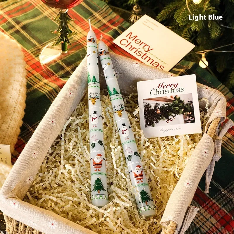 Cylindrical Christmas printed paraffin candle in bright red, 2.2 x 25 cm, on a wooden table