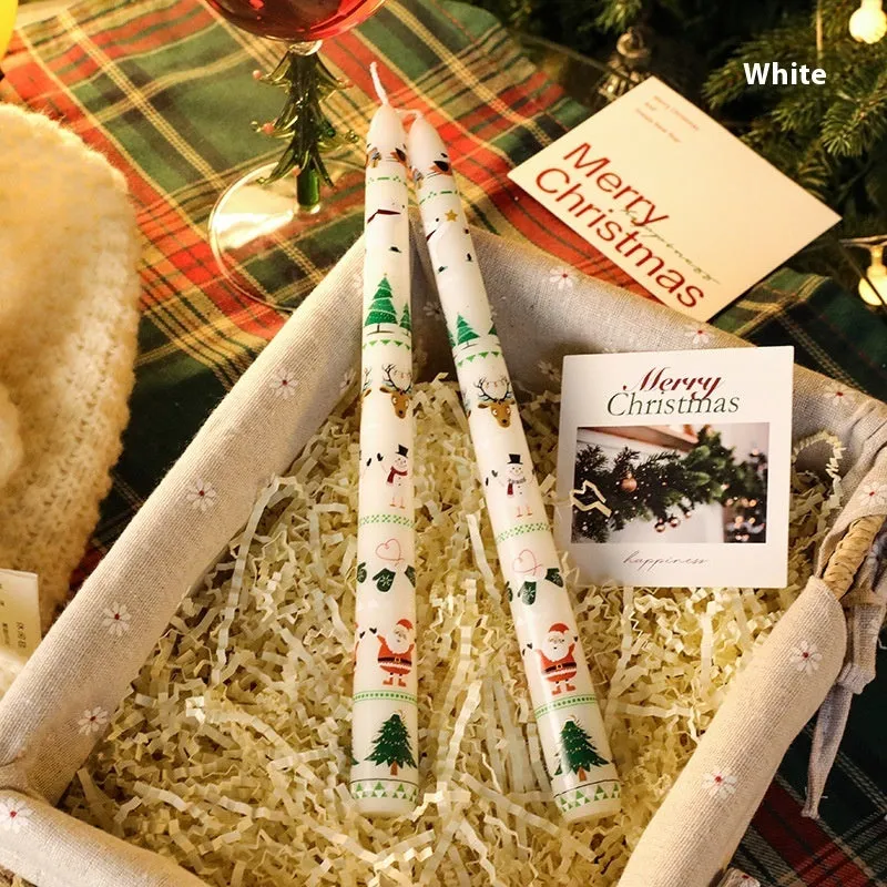 Cylindrical Christmas printed paraffin candle in bright red, 2.2 x 25 cm, on a wooden table