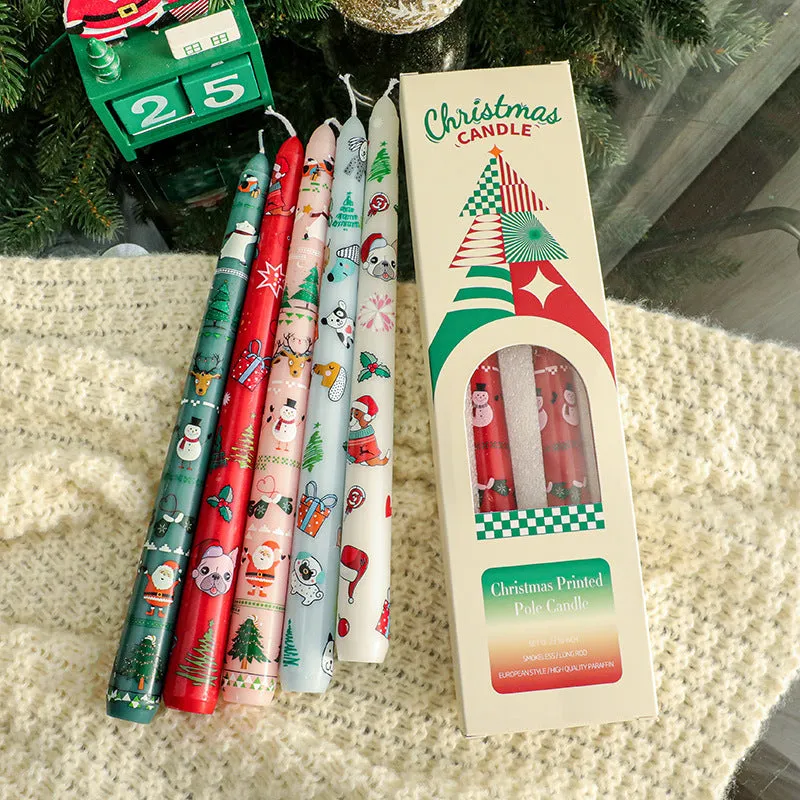 Cylindrical Christmas printed paraffin candle in bright red, 2.2 x 25 cm, on a wooden table