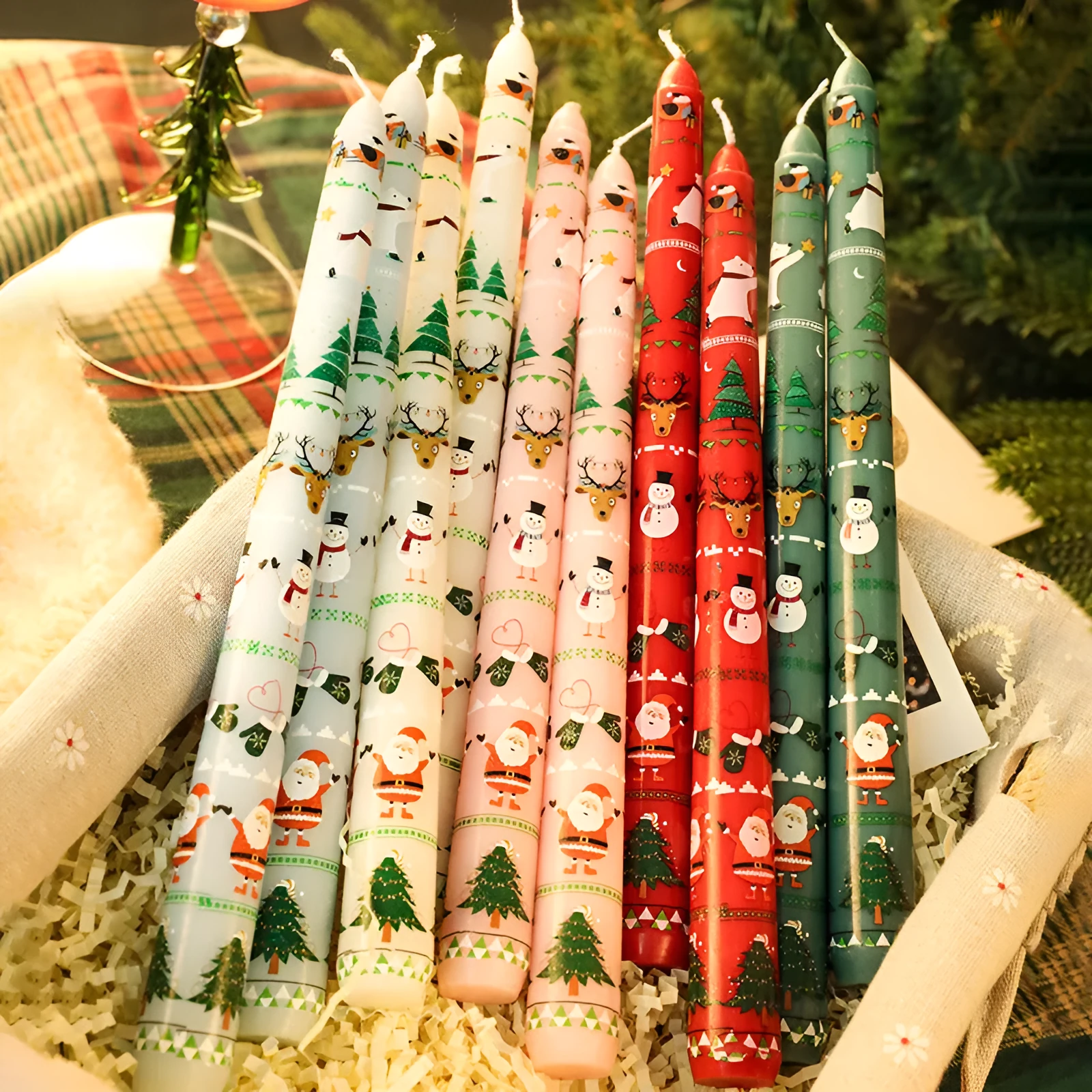 Cylindrical Christmas printed paraffin candle in bright red, 2.2 x 25 cm, on a wooden table