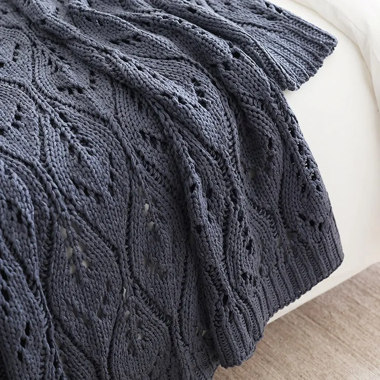 Nordic style knitted acrylic throw blanket 127x152cm in milky white on a sofa