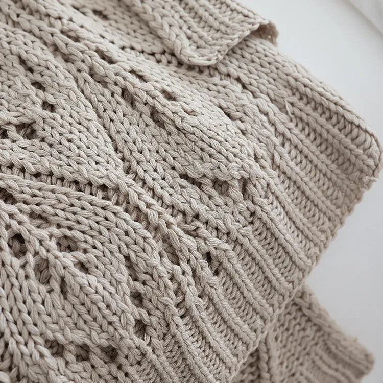 Nordic style knitted acrylic throw blanket 127x152cm in milky white on a sofa