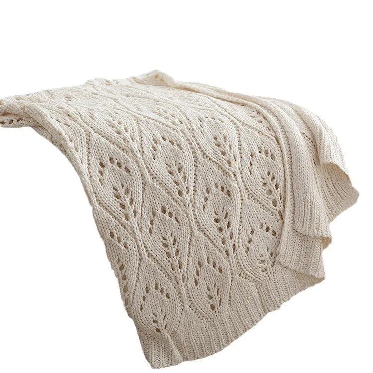 Nordic style knitted acrylic throw blanket 127x152cm in milky white on a sofa