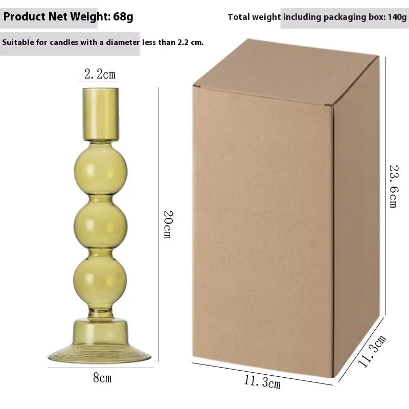 Transparent borosilicate glass three ball mott candle holder in green on a table