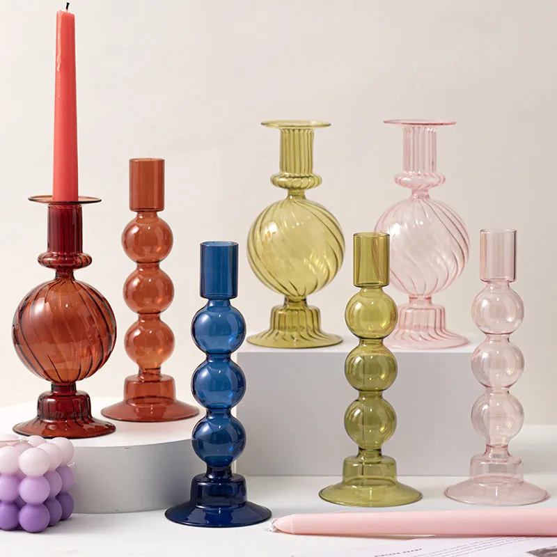 Transparent borosilicate glass three ball mott candle holder in green on a table