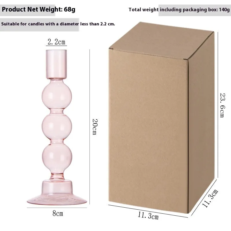 Transparent borosilicate glass three ball mott candle holder in green on a table