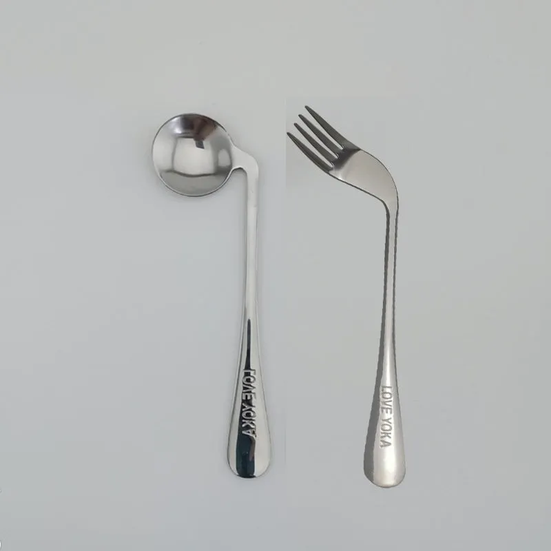Stainless steel adaptive spoon for elderly feeding care, left hand version on white background